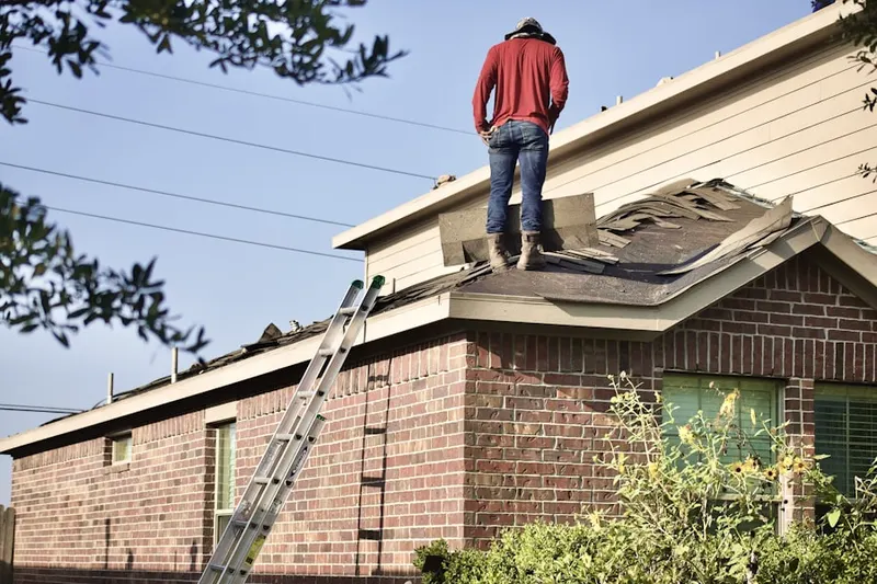 Professional roofer working on a residential roof in Yardville